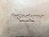 an image of a close up of a leather bag with a logo on it