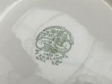 a white plate with a green design on it