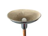 a metal bowl on a wooden stand on a white background