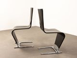 a black chair that is sitting on a concrete floor