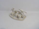 a small tray with cups and saucers on it