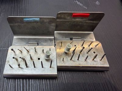 a metal wall mounted with screws and nails on it