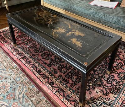 a black coffee table on a rug in a living room