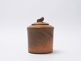wooden lidded jar with a bird on the top