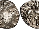 a silver coin with an image of a horse on it