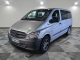 a picture of a silver van parked on a checkered floor