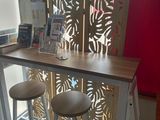 two stools that are sitting in front of a table