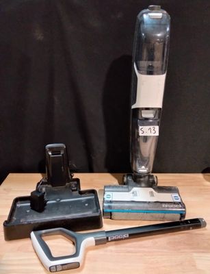 a vacuum that is sitting on a table next to a pair of scissors