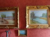 two paintings hanging on the wall next to a vase