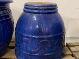 two blue vases sitting on a pallet next to each other