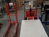 a table that is sitting on a pallet in a warehouse