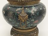 a large vase with a bird on it on a stand