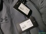 two tags on the back of a gray jacket