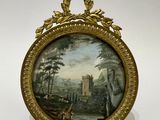 tableau représentant un paysage avec un château en arrière-plan, dans un cadre doré