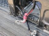 a close up of a car ' s front bumper with wires attached to it