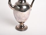 a silver vase with a handle on a white background