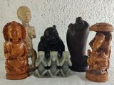 three figurines of buddhas sitting on a table