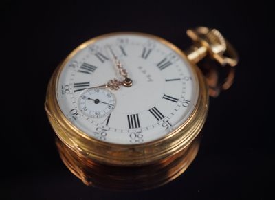 une montre de poche en or avec des chiffres romains