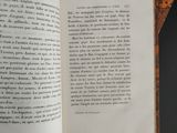an open book on a table with a black table cloth
