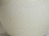 a white vase that is sitting on a table