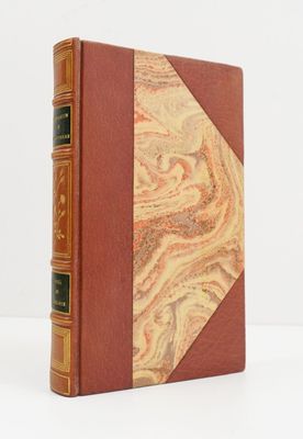an old book with a marbled cover and a leather binding