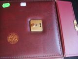 a red leather case with a gold lock on it