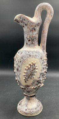 a white vase that is sitting on a table