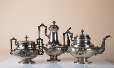 five silver teapots sitting on a white table