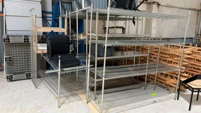 a metal shelving with several shelves and chairs in it