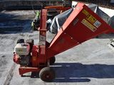 a small red machine that is sitting on the concrete
