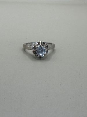 a picture of a diamond ring on a white surface