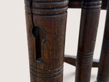 a close up of a wooden chair with a wooden seat
