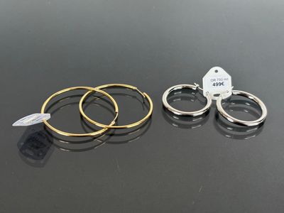 three rings with tags on them sitting next to each other