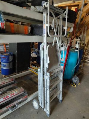 a stack of boxes and other items in a garage