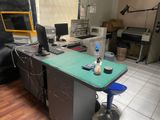 a desk with a computer on top of it in a room