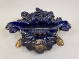 a blue and gold bowl on a white table