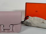 a small pink bag with a handle and a small pouch