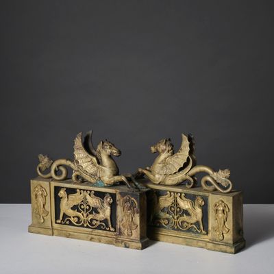 pair of antique brass figurines of horses and a man on a sleigh