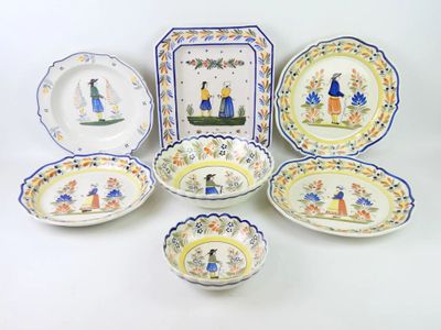 several plates and bowls are arranged on a white surface
