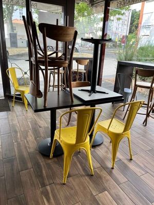 tables and chairs in a restaurant with a view of the outside