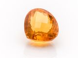 an orange topazte gems on a white surface