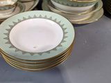 a lot of plates and cups sitting on a table