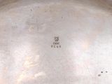 a silver plate with a chinese writing on it