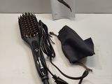 an image of a hair dryer and brush on a table