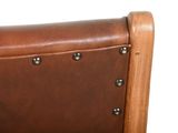 a close up of a brown leather chair with rivets on the back