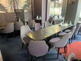 many chairs around a long table in a restaurant
