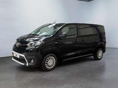 the black van is parked in a large room with white walls