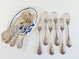 six forks and a bowl of silverware on a table