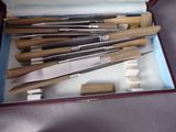 a bunch of knives in a box on a table