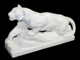 a white statue of a lion on a black background